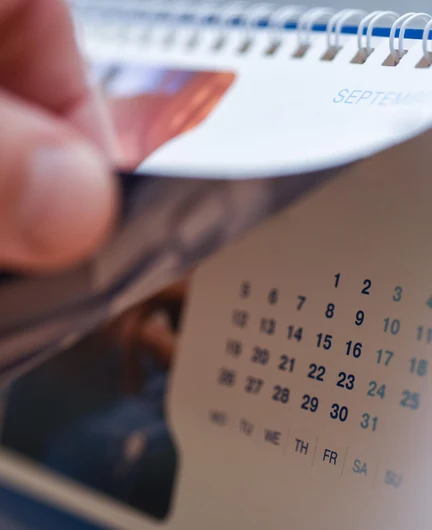 3eb82bb4-591f-4d05-b9bf-343428bc379c-hand-turns-page-desk-calendar.jpg